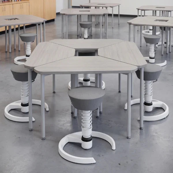 Aeris Swopper ergonomic office stools arranged around grey collaborative classroom tables.
