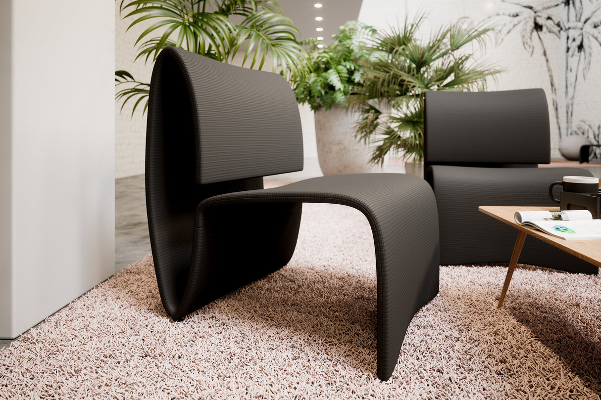 Modern black mesh reception chair with curved design in a stylish office lobby