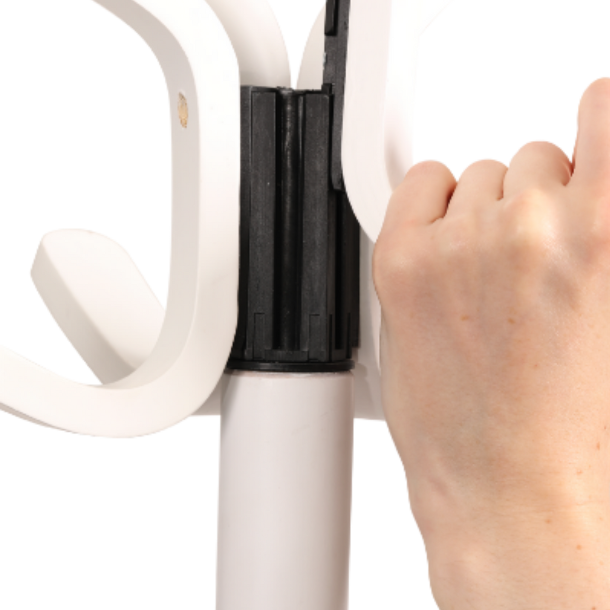 Hand assembling white wood coat stand with multiple hooks and sturdy black connector