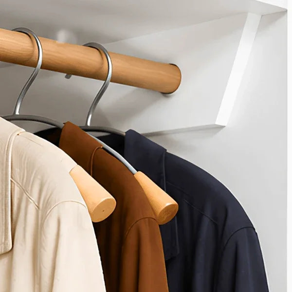 Alba silver metal and wood clothes hangers holding jackets in a wardrobe