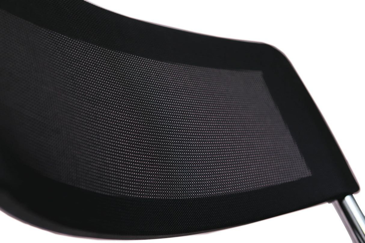 Close-up of black mesh backrest on folding chair with chrome frame