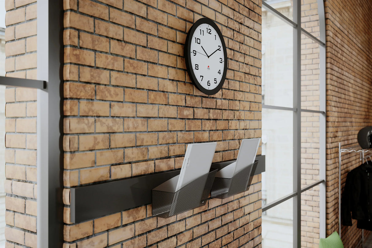 Wall-mounted clock and document organizer on brick wall for office or school workspace
