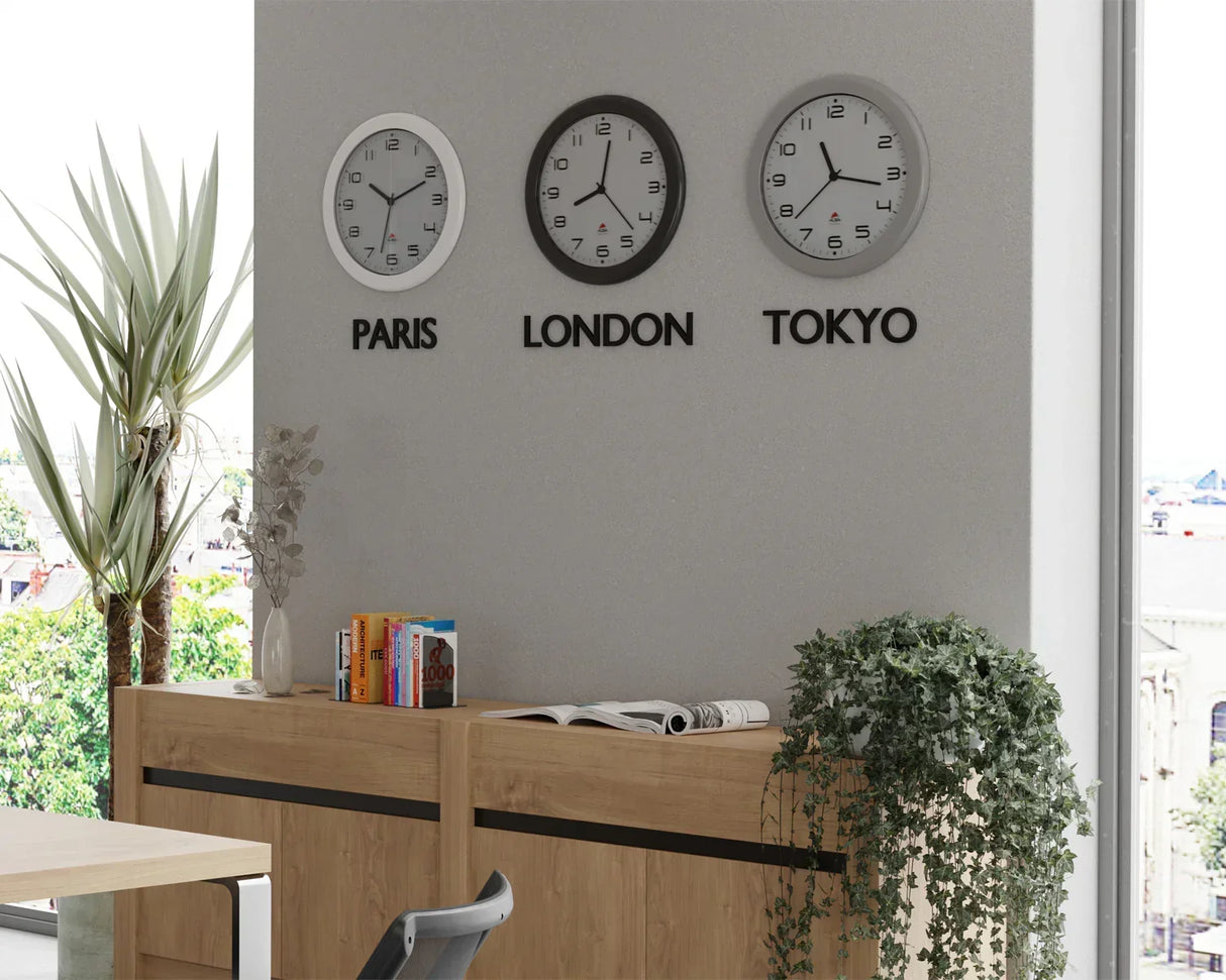 Wall clocks showing Paris, London, Tokyo time in modern office with plants and books
