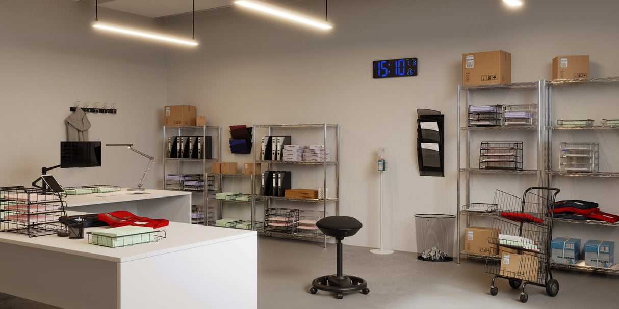 Mesh metal magazine holder in silver grey mounted on office wall, organizing documents by shelves.