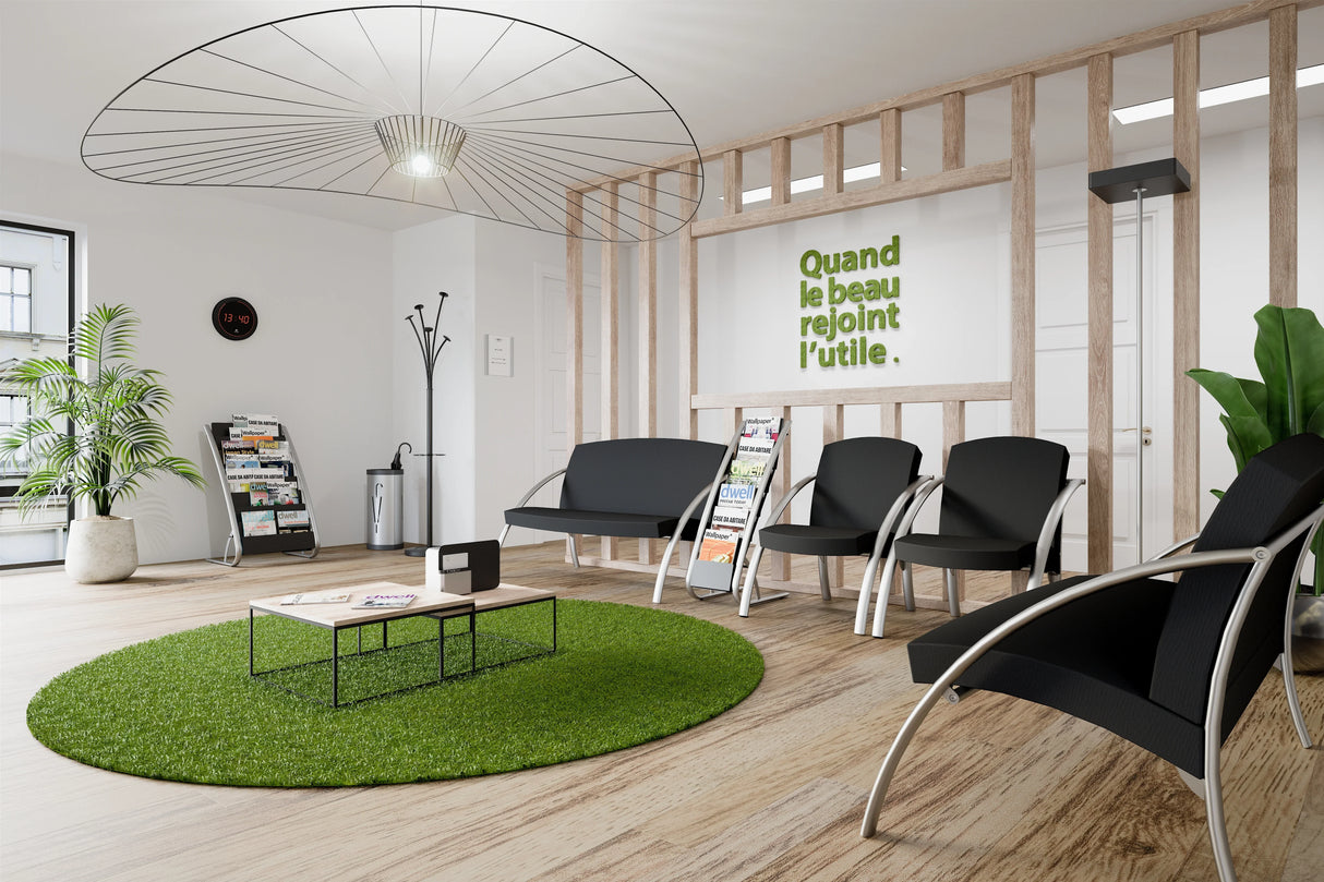 Modern office waiting room with black two-seat reception chairs, magazine stands, and contemporary decor