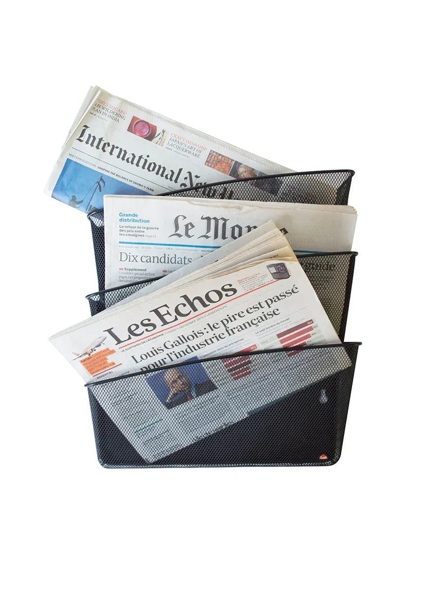 Black mesh newspaper holder with International New York Times, Le Monde, and Les Echos