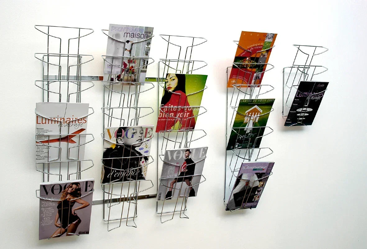 Wall-mounted metal magazine racks displaying Vogue and other publications for office or home organization