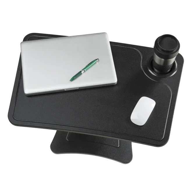 Black standing desk with laptop, green pen, mouse, and travel mug for home office productivity