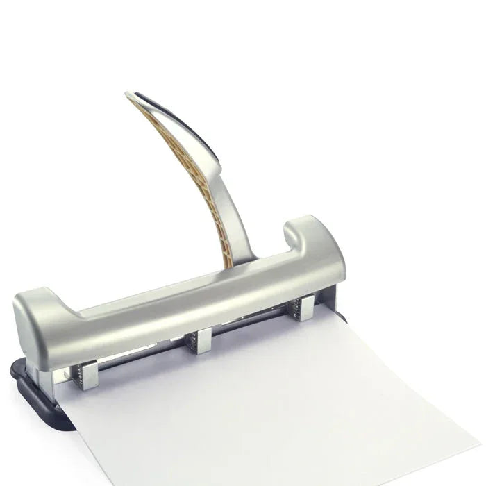 Silver heavy-duty hole puncher with paper, ideal for office or school organization tasks.