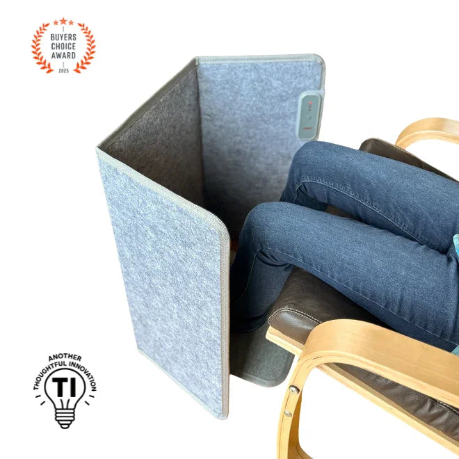 Person using gray foot and leg heater panel while sitting in a chair, ergonomic home office accessory
