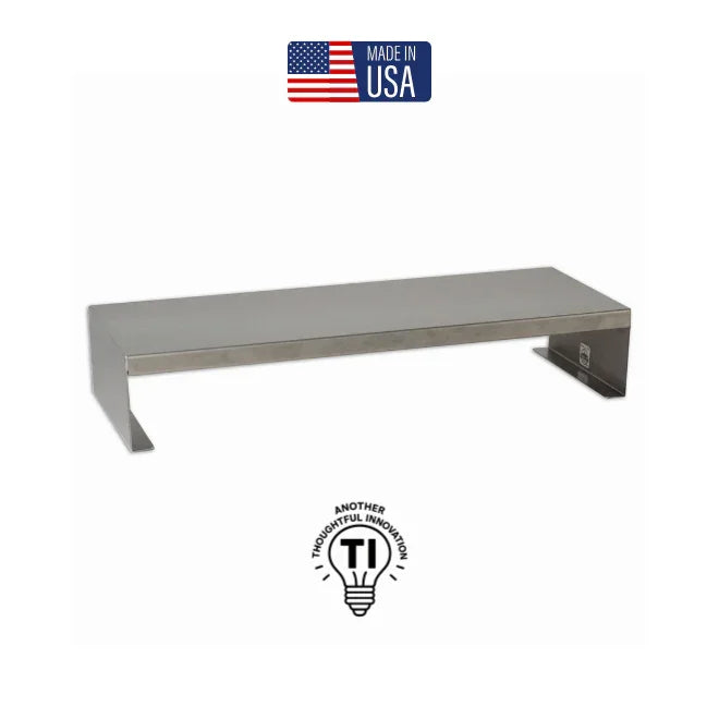 Stainless steel monitor riser stand, minimalist design, Made in USA, sits on white background.