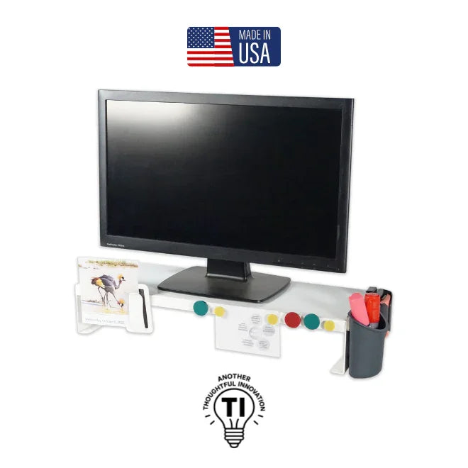 White monitor riser with a computer screen, pen holder, file organizer, and colorful magnets