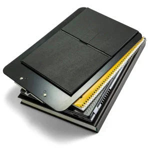 Magnetic clipboard with easel back stacked on spiral notebooks and folders