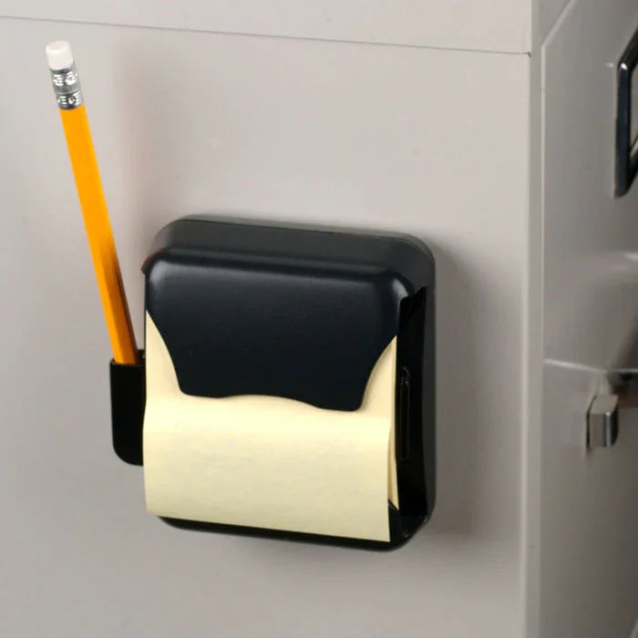 Magnetic pop-up note dispenser with pencil holder attached to a metal cabinet