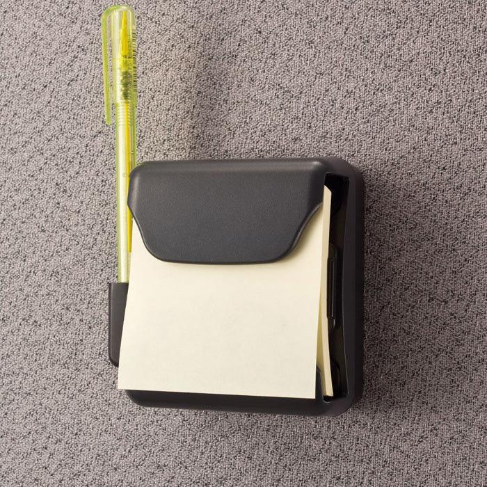 Magnetic pop-up note dispenser with yellow pen attached to gray fabric office wall