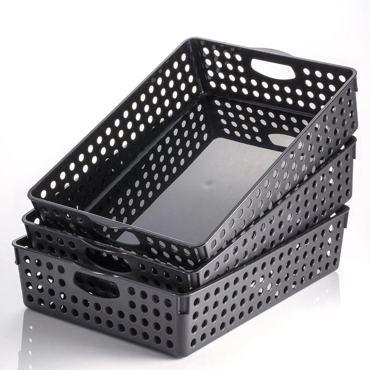 Stacked black plastic nested storage baskets with handles and perforated sides