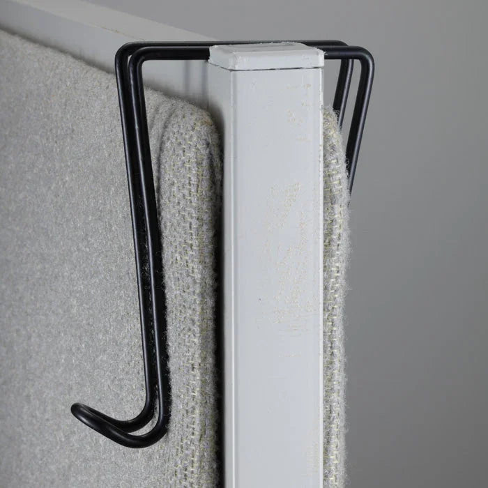 Black wire cubicle hook attached to an office partition wall