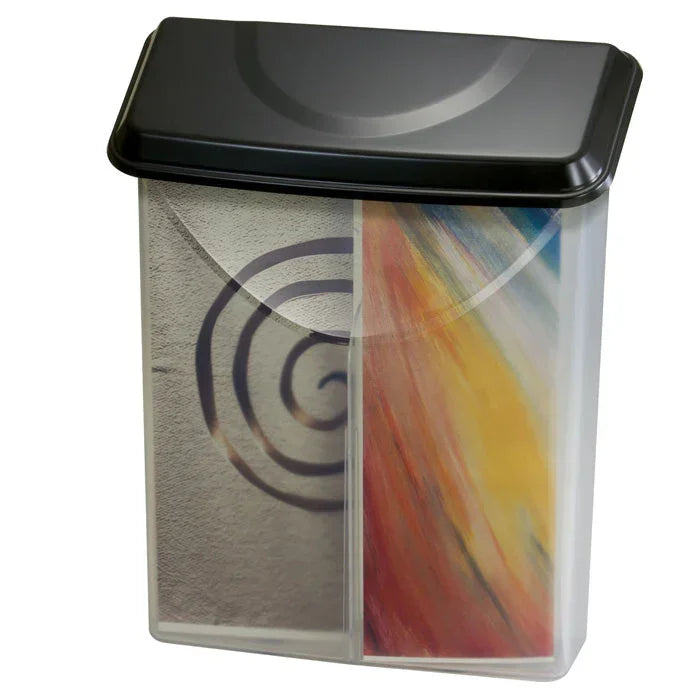 Clear dual-compartment storage bin with black lid, holding spiral notebook and colorful art supplies for office or school organization