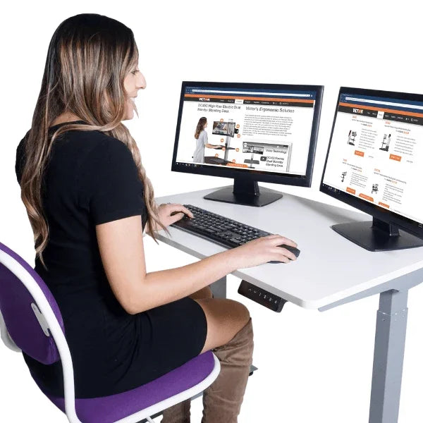 Woman working at a Victor® High Rise™ Height Adjustable Compact Electric Standing Desk