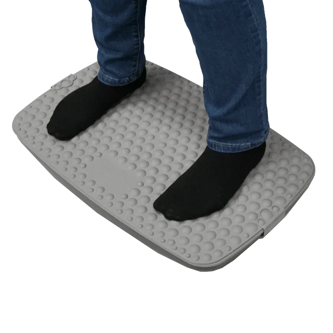 Person standing on a gray ergonomic anti-fatigue standing desk mat with textured surface