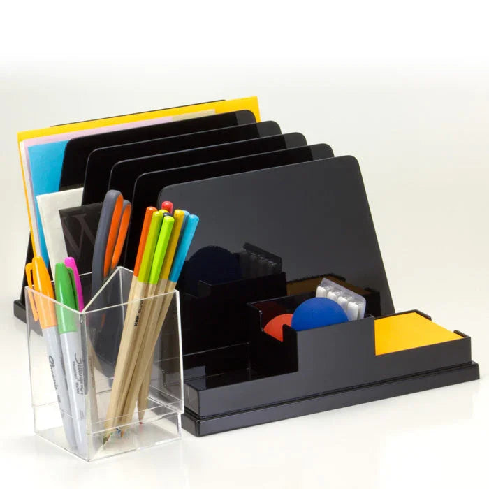 Desk organizer with document slots, pencil cup, pens, and office supplies on a white surface.