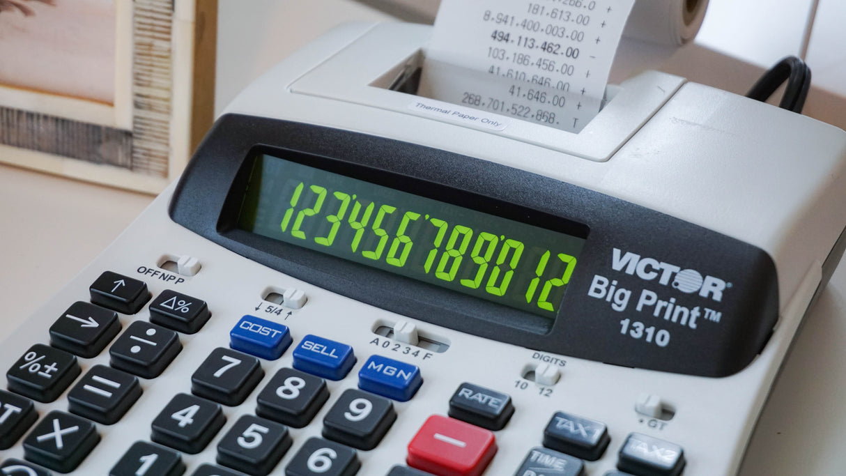 Thermal printing calculator with large display and printed paper roll on desk