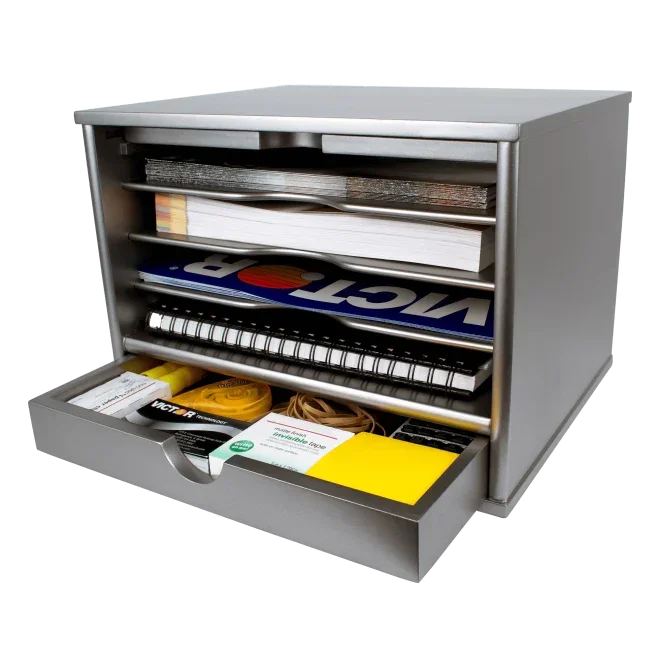Silver metal desk organizer with drawers holding notebooks, tape, and office supplies for workspace organization
