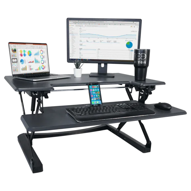 High-rise adjustable standing desk with keyboard tray, monitor, laptop, phone, and office accessories