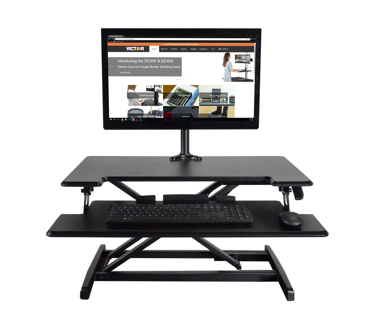 Adjustable height standing desk with keyboard tray, monitor, and workspace essentials