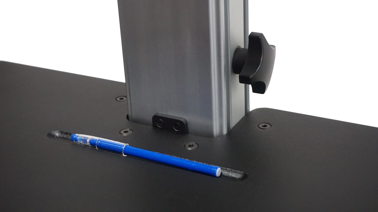 Close-up of dual monitor standing desk surface with built-in pen holder and adjustment knob
