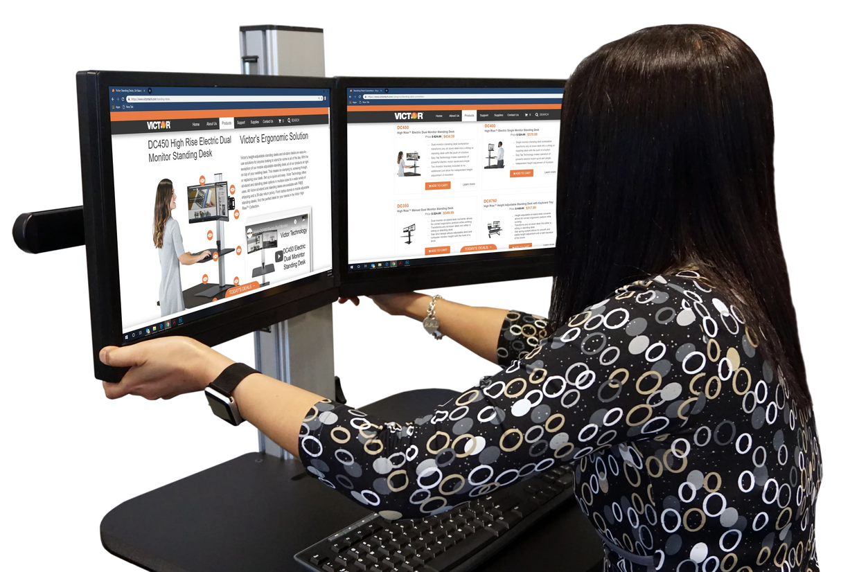 Woman using a high-rise dual monitor standing desk with adjustable screens in an office