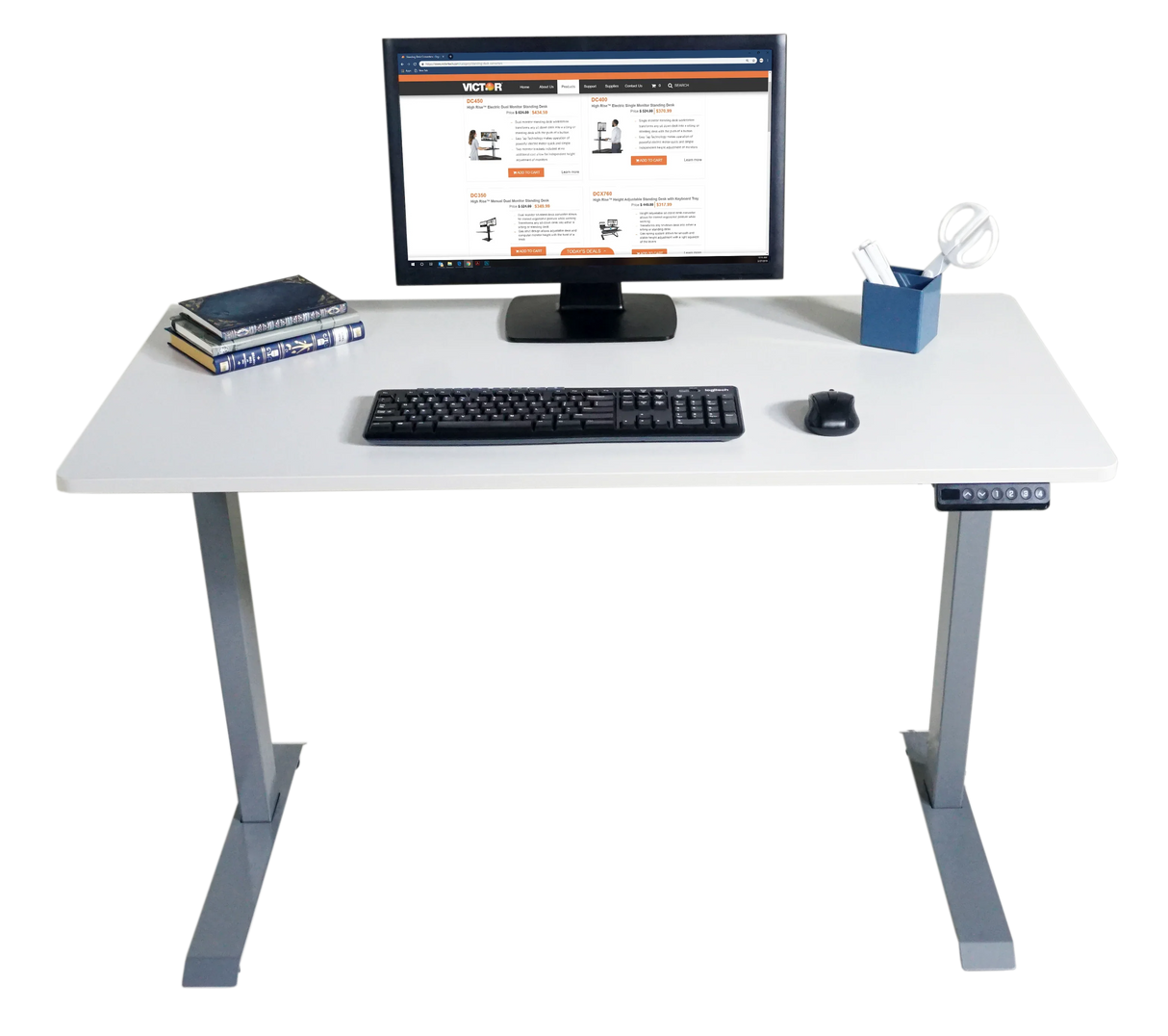 Electric adjustable height standing desk with monitor, keyboard, books, and office supplies