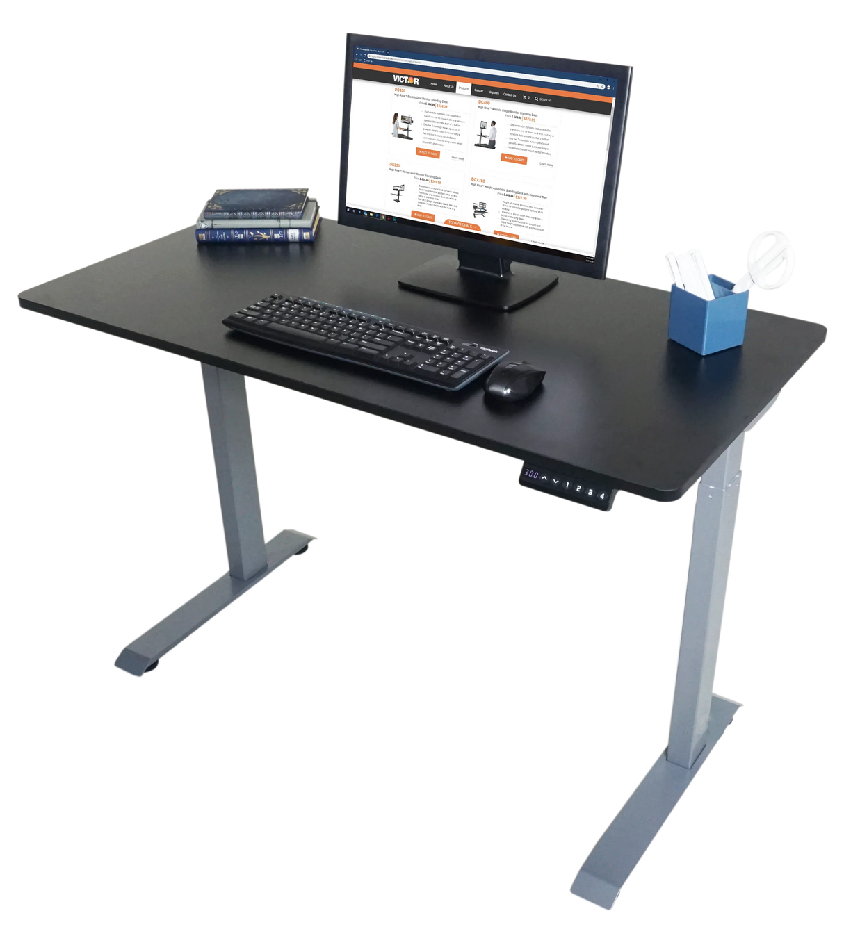 Electric adjustable height standing desk with monitor, keyboard, books, and pen holder