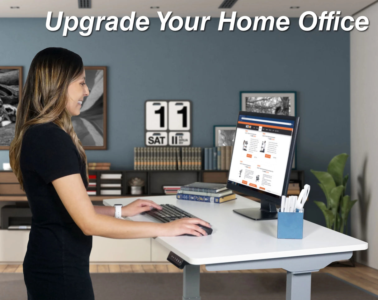 Woman using an electric adjustable height standing desk in a modern home office with a computer
