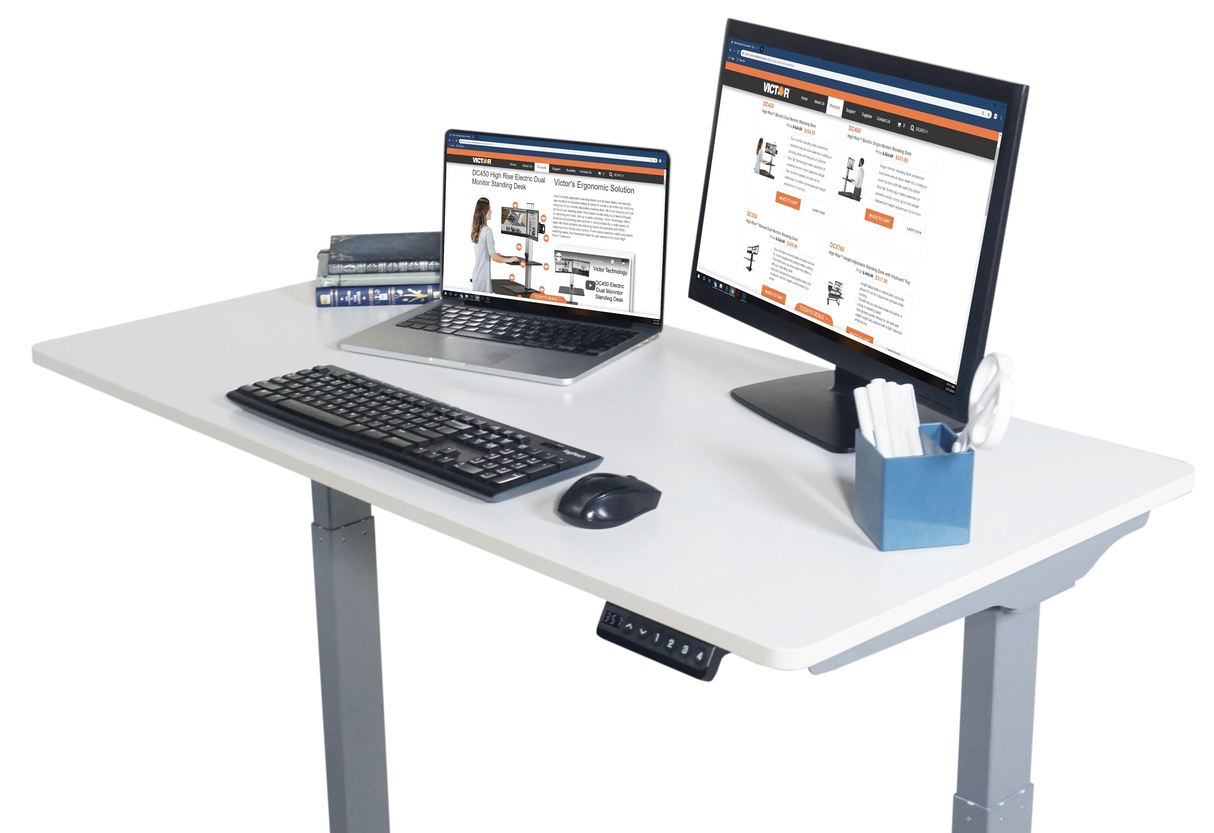 Electric adjustable standing desk with monitor, laptop, keyboard, and office supplies