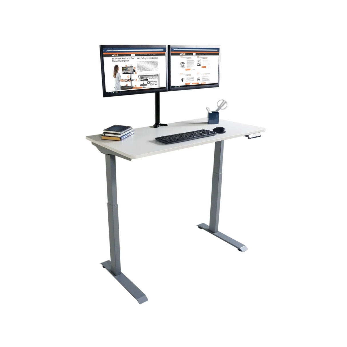 Electric adjustable height standing desk with dual monitors, keyboard, books, and office supplies