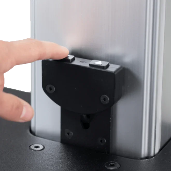 Hand pressing electric height adjustment button on standing desk