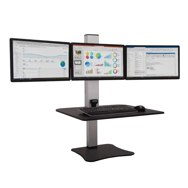 High-rise electric standing desk with triple monitors, keyboard, and mouse for office workspace