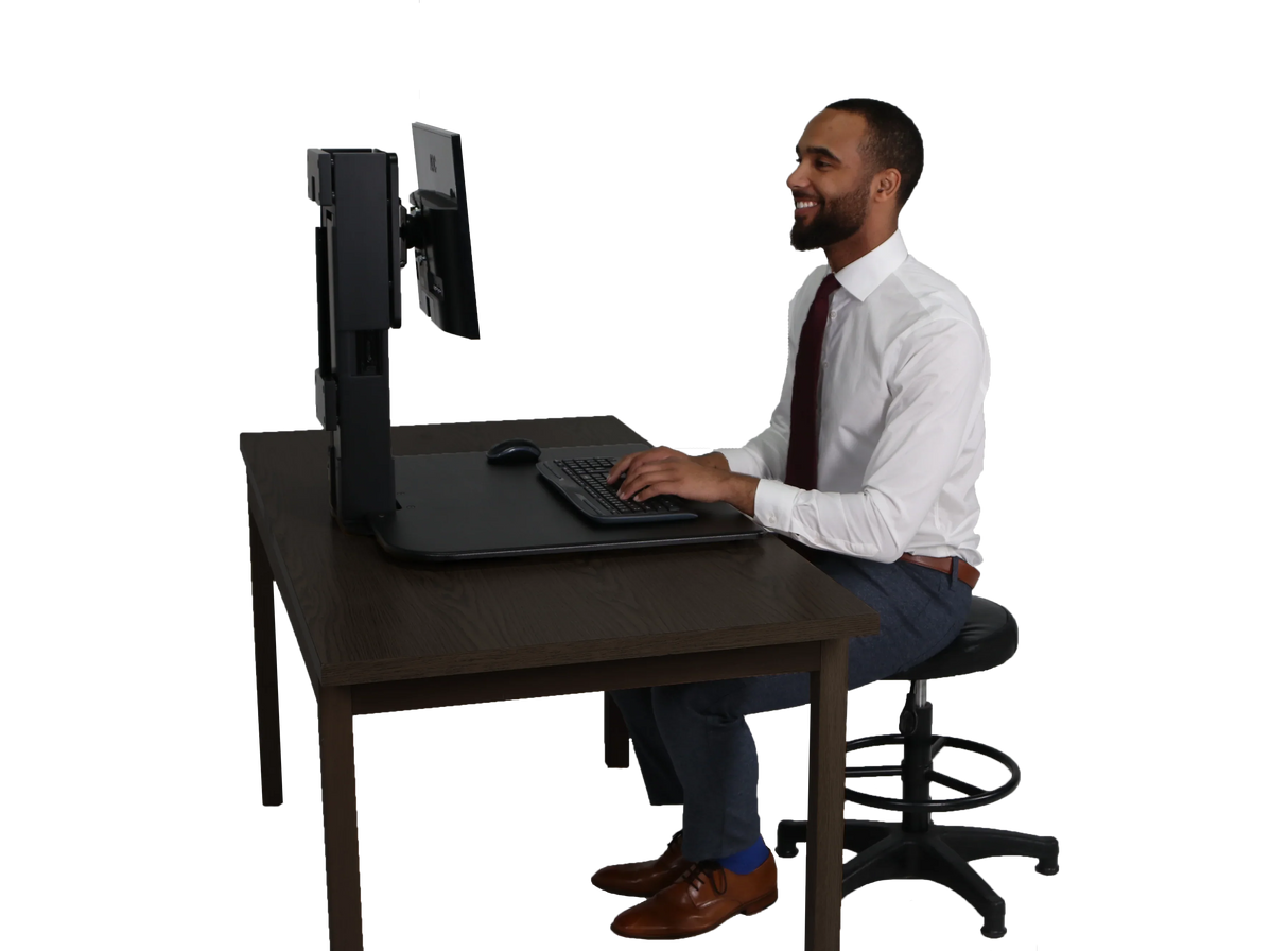 Man using high-rise single monitor standing desk on office table with keyboard and mouse