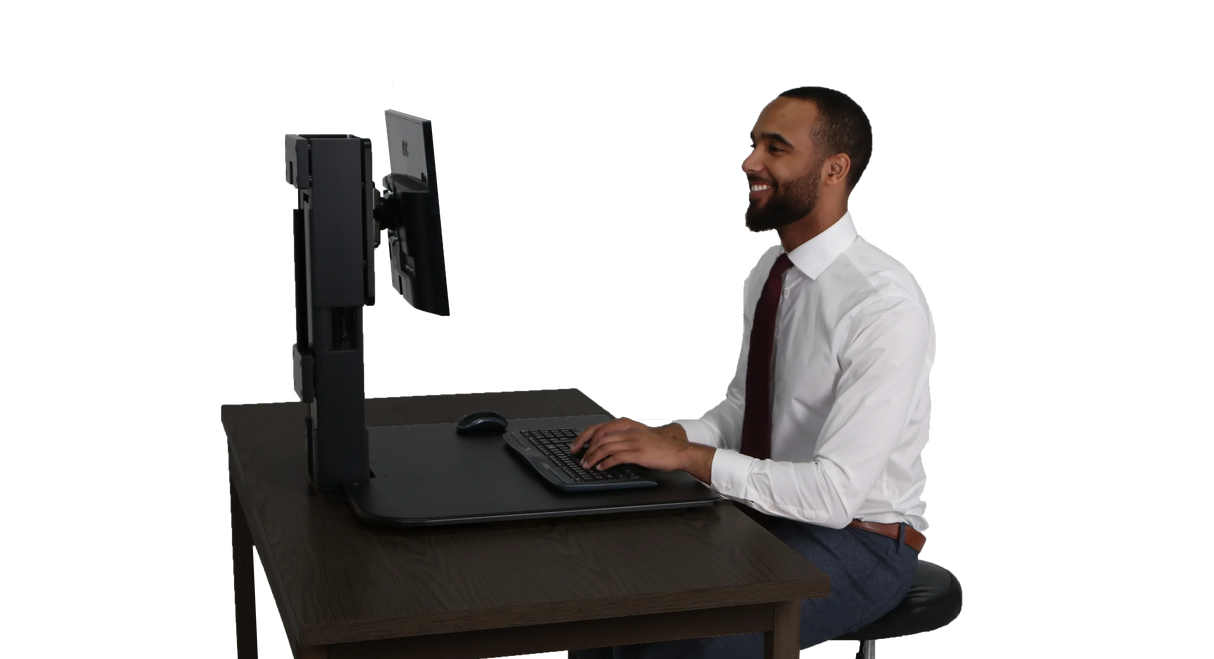 Man using high rise single monitor standing desk converter at office workstation