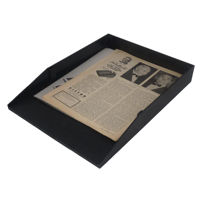 Black office letter tray holding documents and a newspaper, desktop organizer