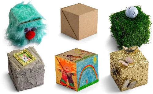 Six uniquely decorated storage cubes, including furry, cardboard, grass, concrete, painted, and glitter gold designs, displayed on a white background.