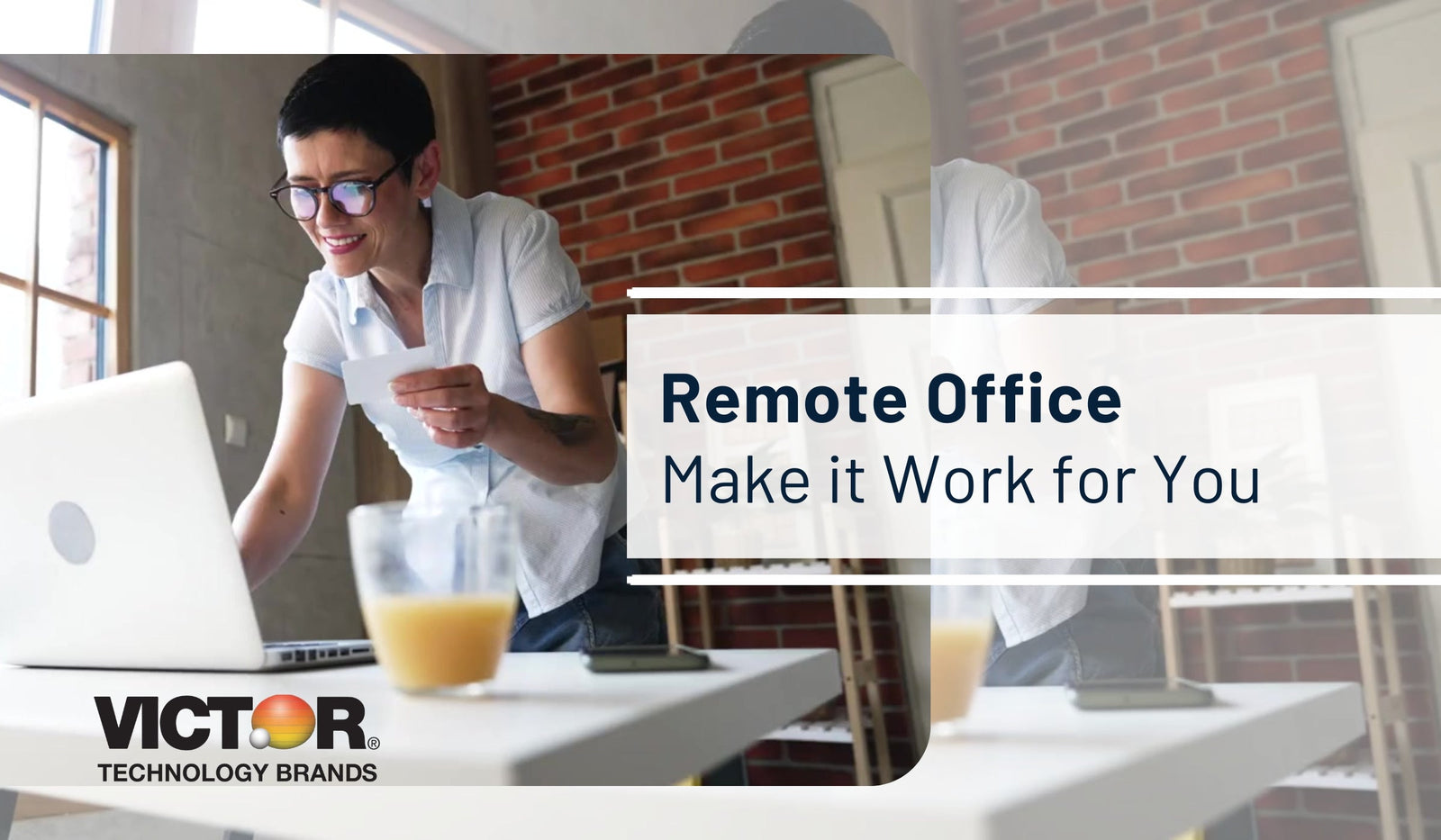 Person working remotely at a modern desk with laptop and office supplies in home office setting