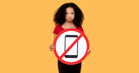 student-holding-a-cell-phone-ban-in-school-sign