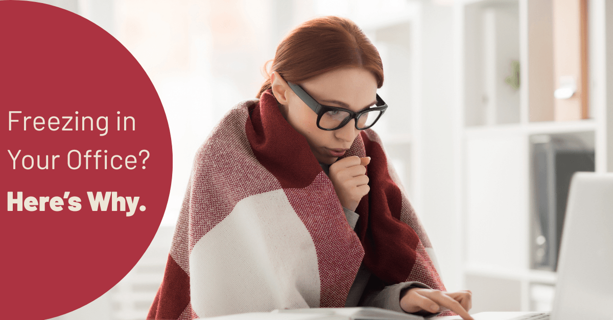 Office employee using a Heetz heated desk pad in a cold air-conditioned workplace