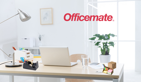 Modern office desk with laptop, Officemate logo, organizer, lamp, and potted plant in background