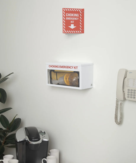 Wall-mounted choking emergency kit medical cabinet in office breakroom with coffee maker and phone