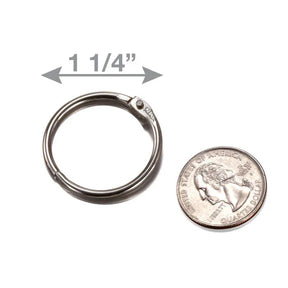 Officemate 1 1/4-inch diameter loose leaf ring next to a US quarter for scale.