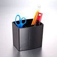 Black pencil cup organizer holding blue scissors, pencils, and a red ruler on a desk