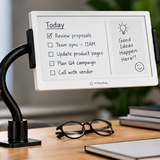 TRMNL ePaper dashboard display with a checklist on a desk next to glasses and notebooks